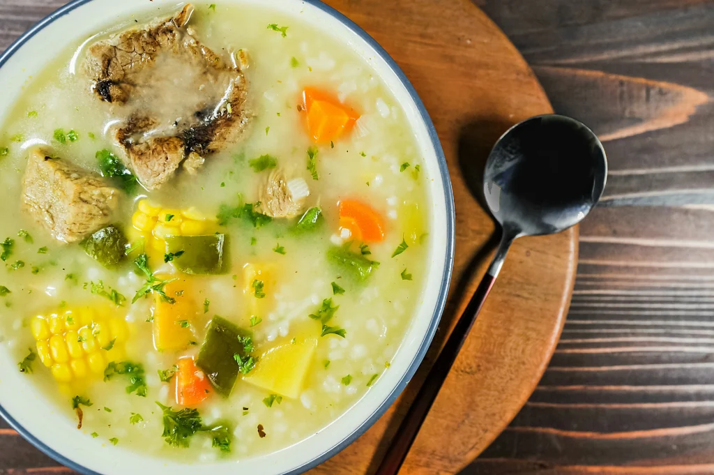Chalet Chicken Soup with tender beef, corn, carrots, potatoes, green peppers, rice, and fresh parsley in a rich, creamy broth.